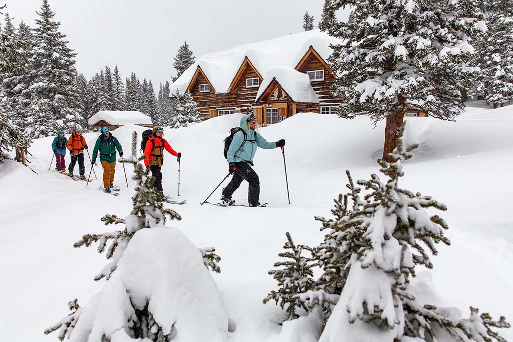 Group of skiers departing lodge for backcountry adventure