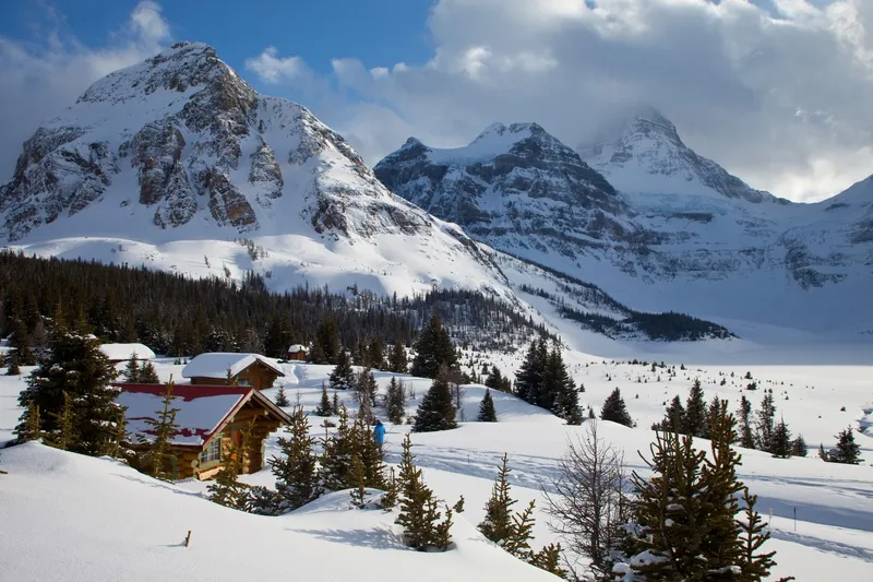 Cabin in winter landscape with peaks
