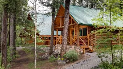 Cathedral Mountain Lodge exterior with cabins along the Kicking Horse River