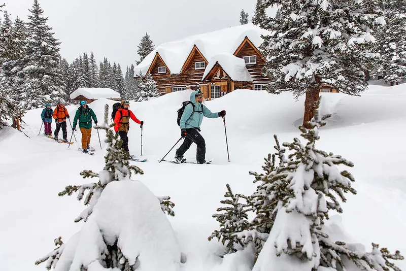 Group of skiers departing lodge for backcountry adventure