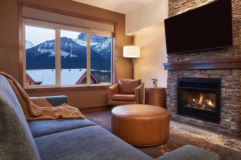 Cozy living room with fireplace and mountain view at Stoneridge Mountain Resort